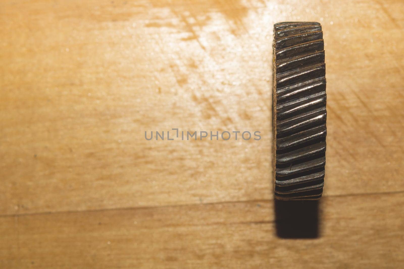 Metal gear on a wooden background. detail of mechanism