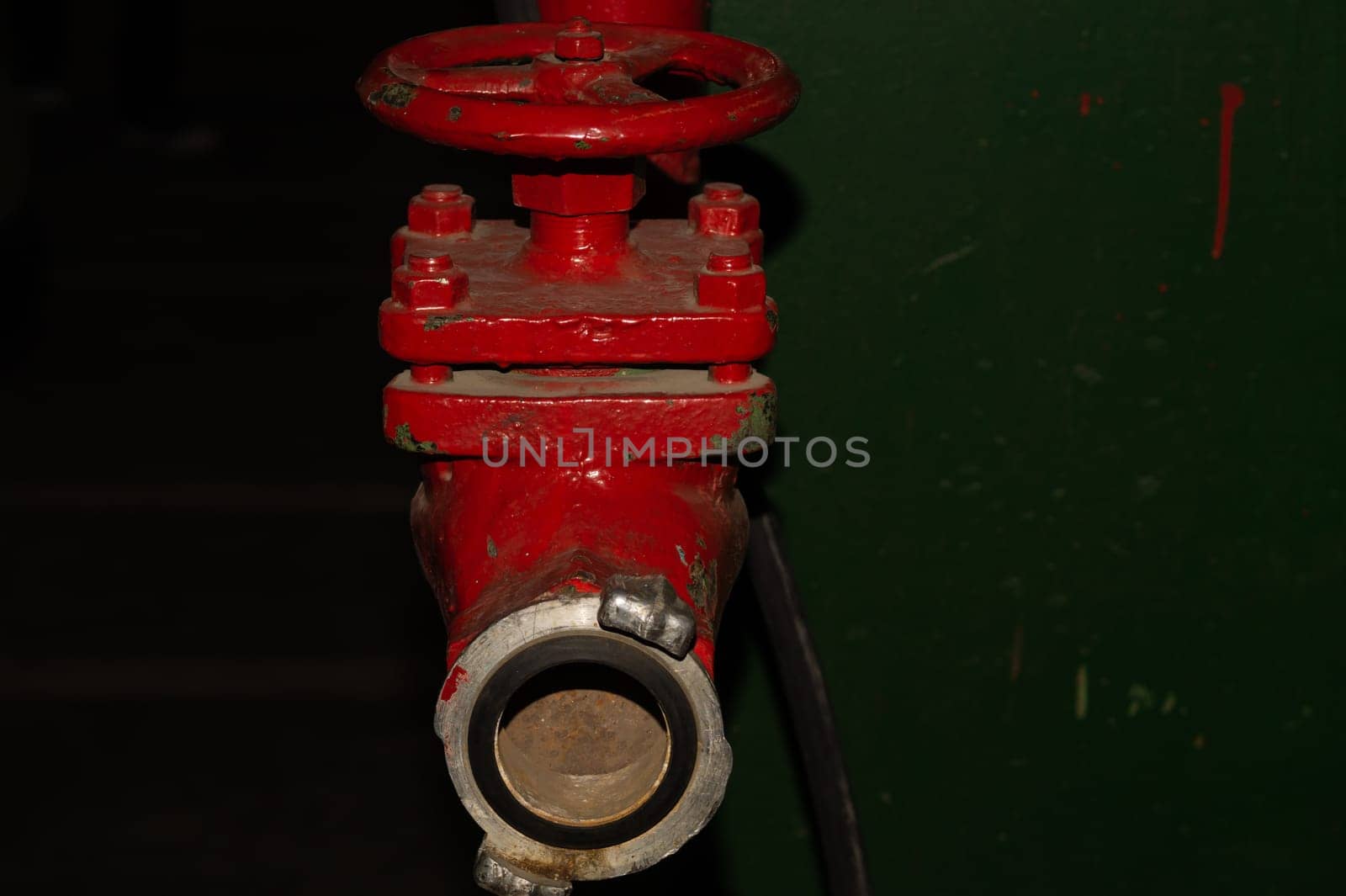 Red valve installed at fire hydrant pipe. old industrial faucet