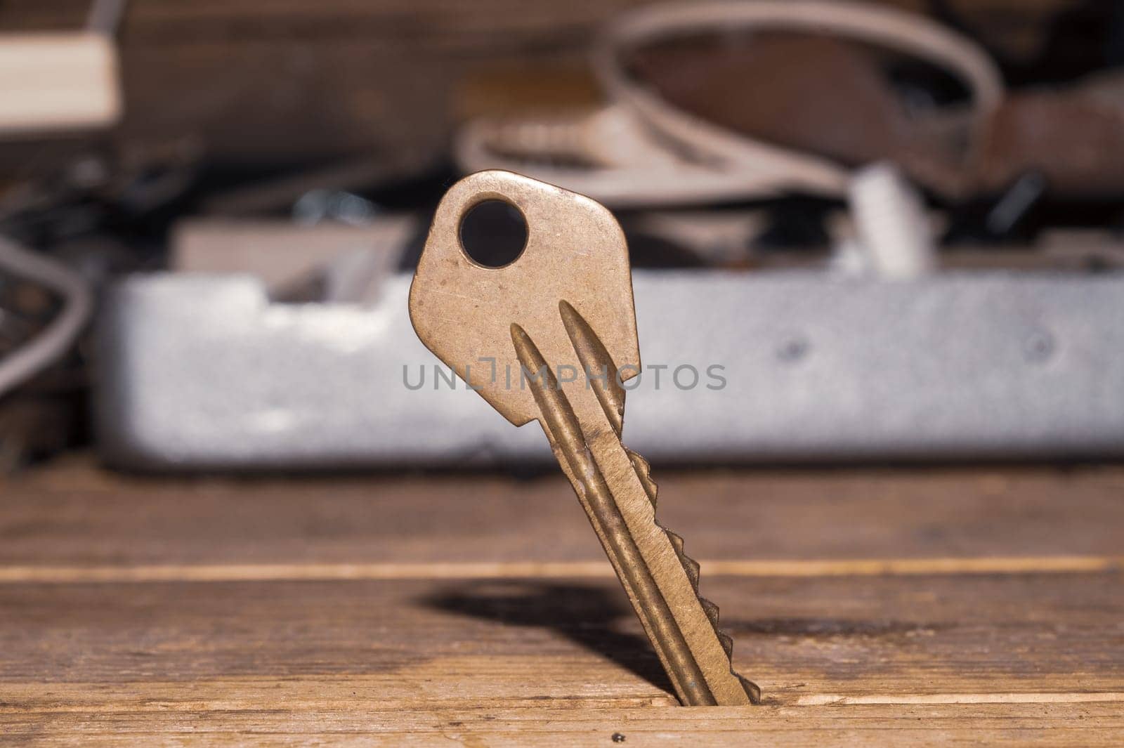 Key stuck in the table. key on wooden background. safety and security concept