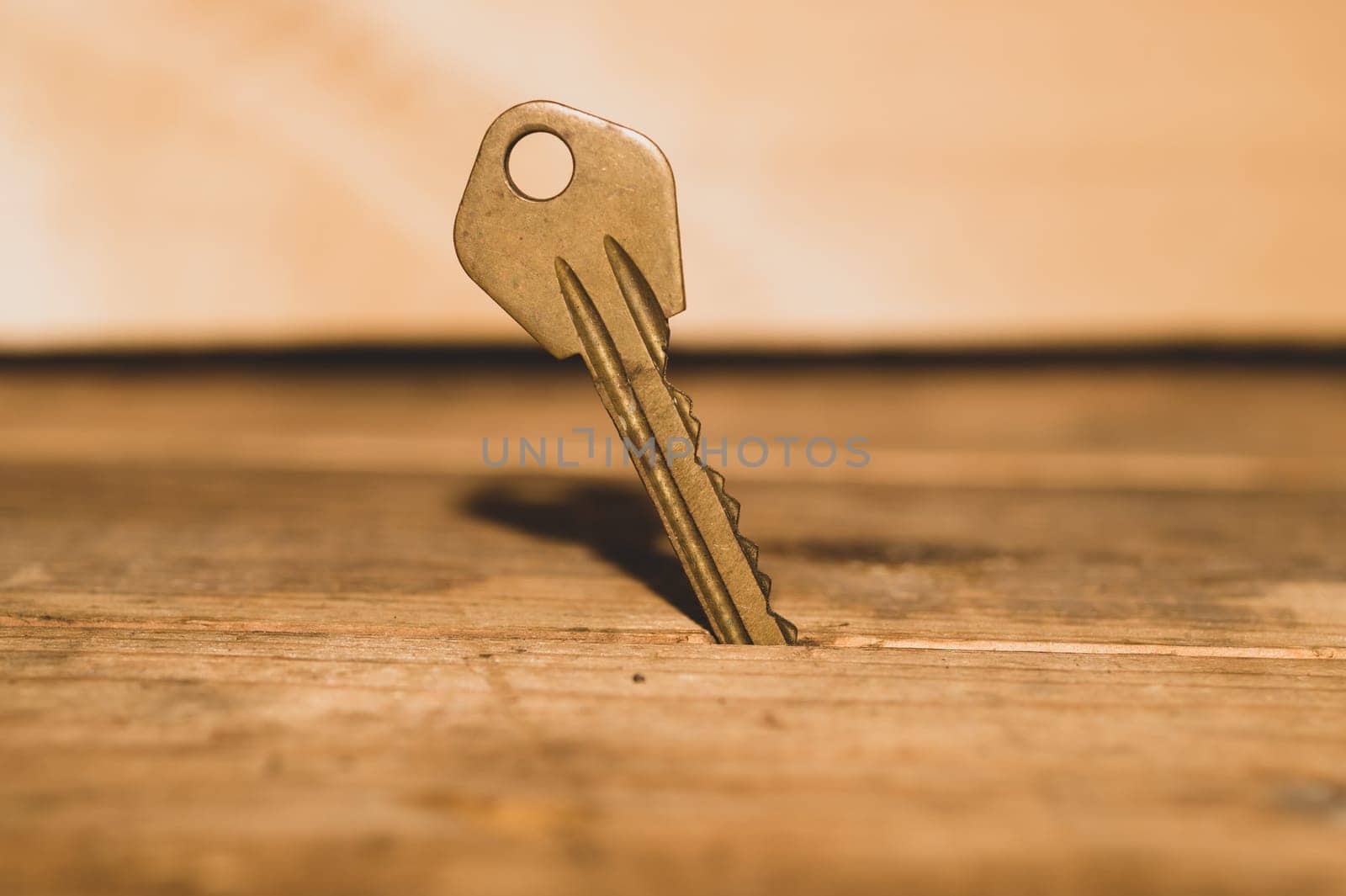 Key stuck in the table. key on wooden background. safety and security concept