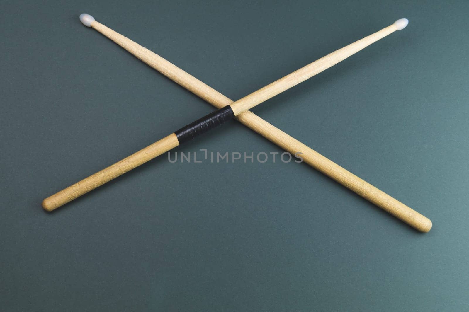 A pair of wooden drumsticks isolated on color background. copy space