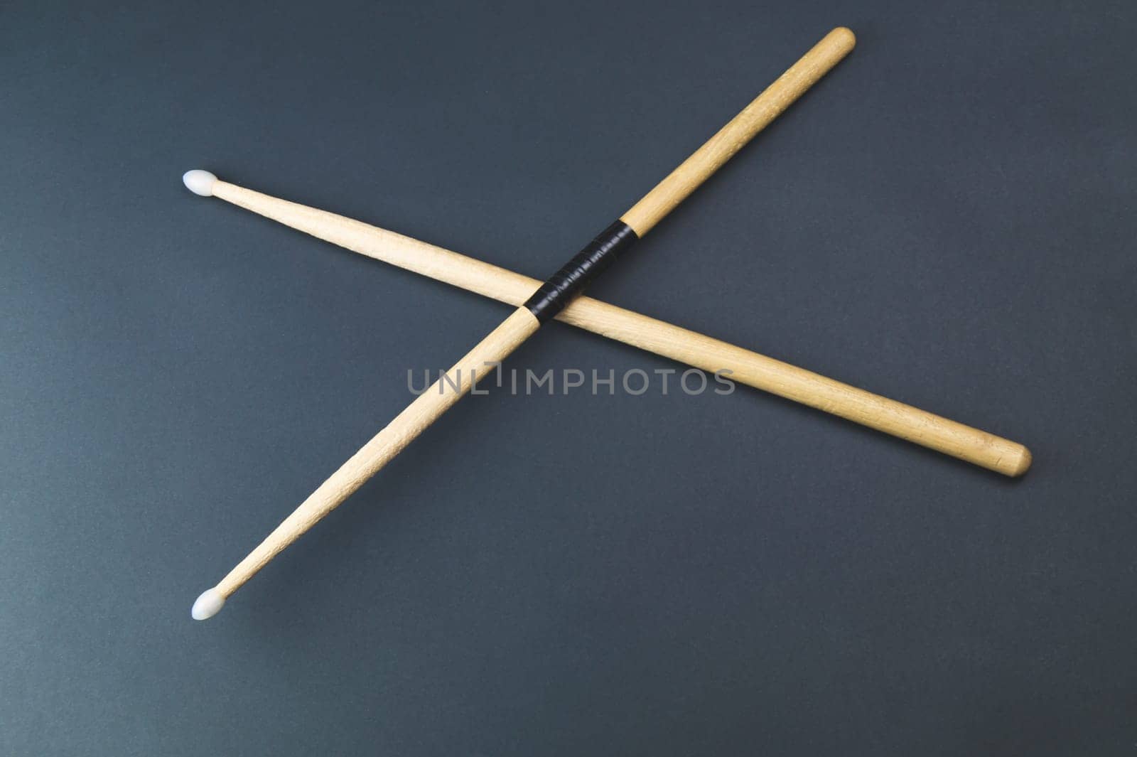 A pair of wooden drumsticks isolated on color background. copy space