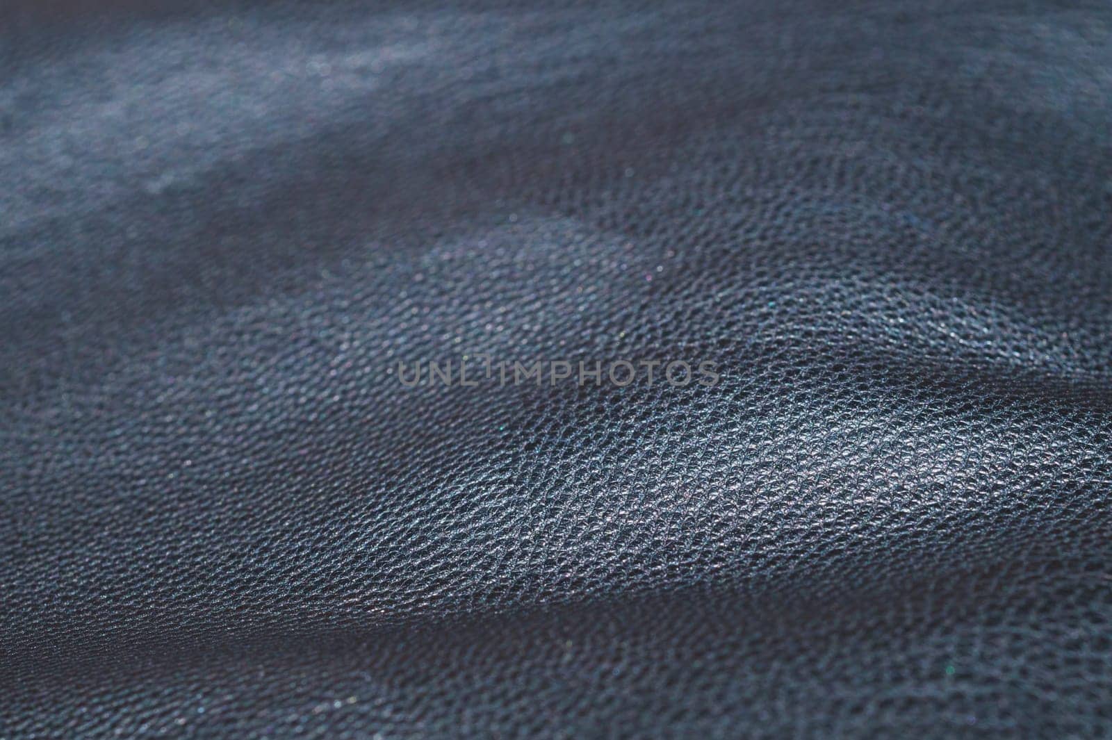 Black leather close up. rough material abstract background