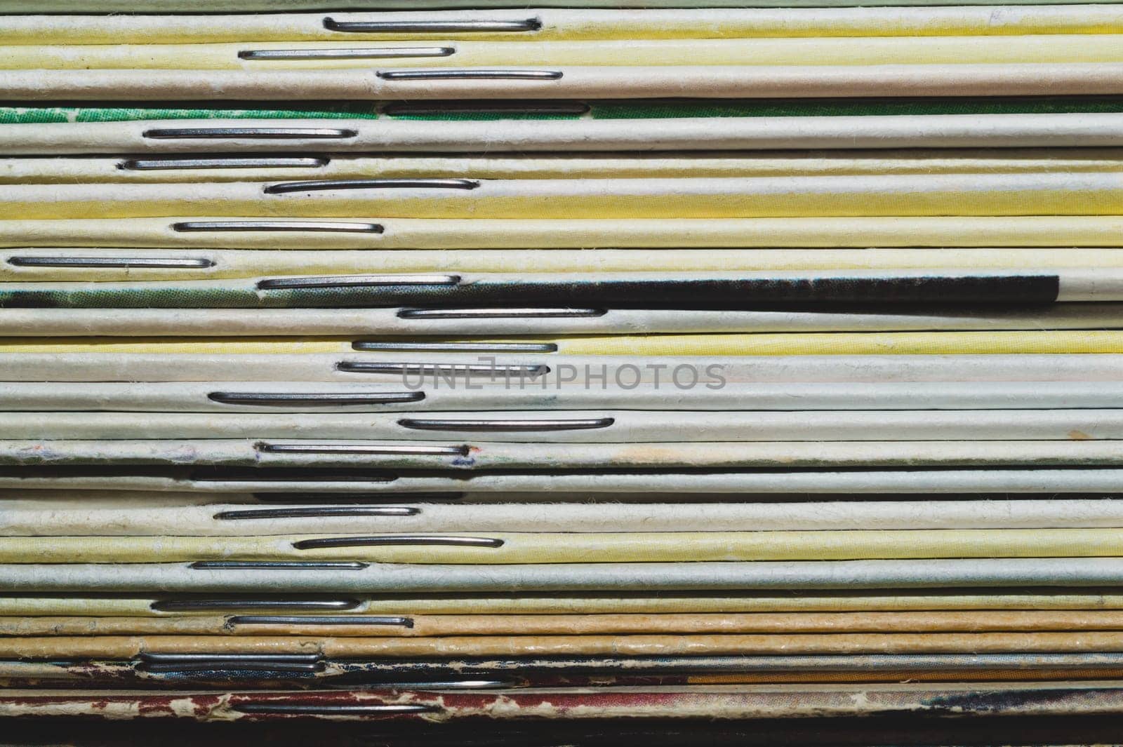 Stack of old magazines. pile of retro newspapers. vintage journals lie on top of each other