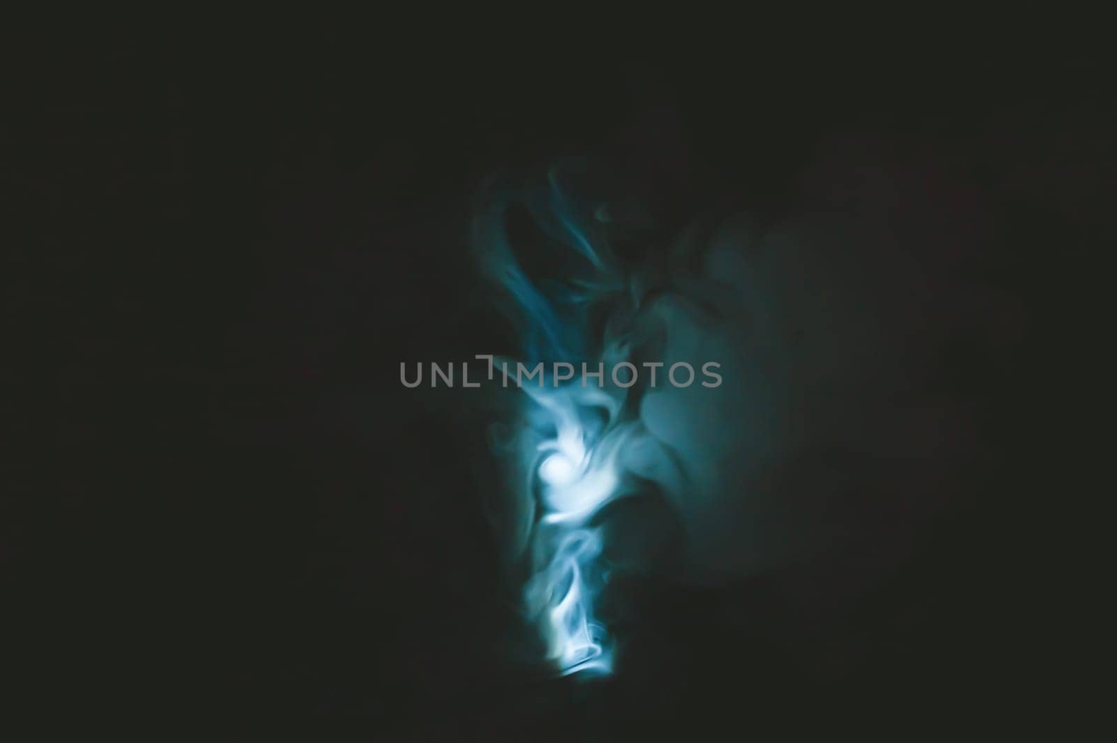 Turquoise smoke on black backdrop. color fog abstract background
