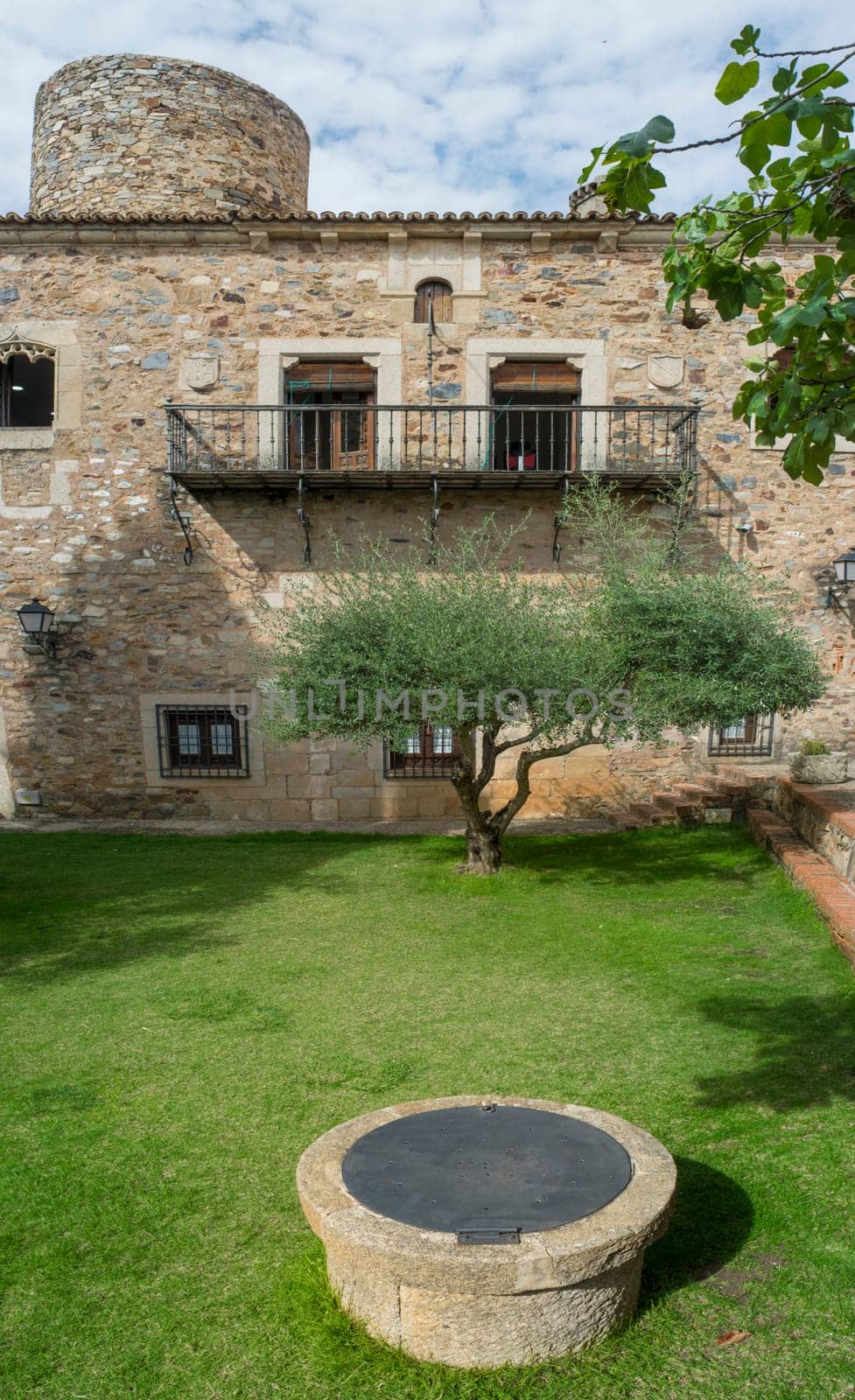 Caceres, Spain - Oct 1st, 2021: Palace of Carvajal garden. One of the most emblematic building of monumental Complex of Caceres, Extremadura, Spain
