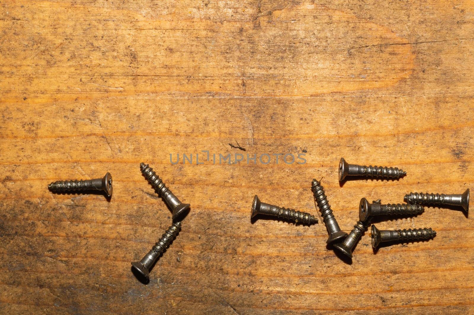 Screws on a wooden background.working tools. copy space