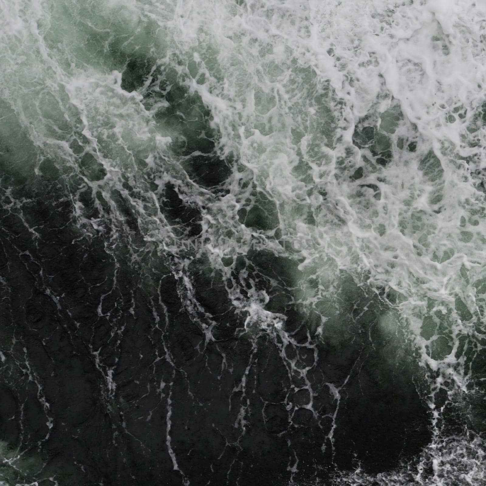 Big water splash seen from above a boat