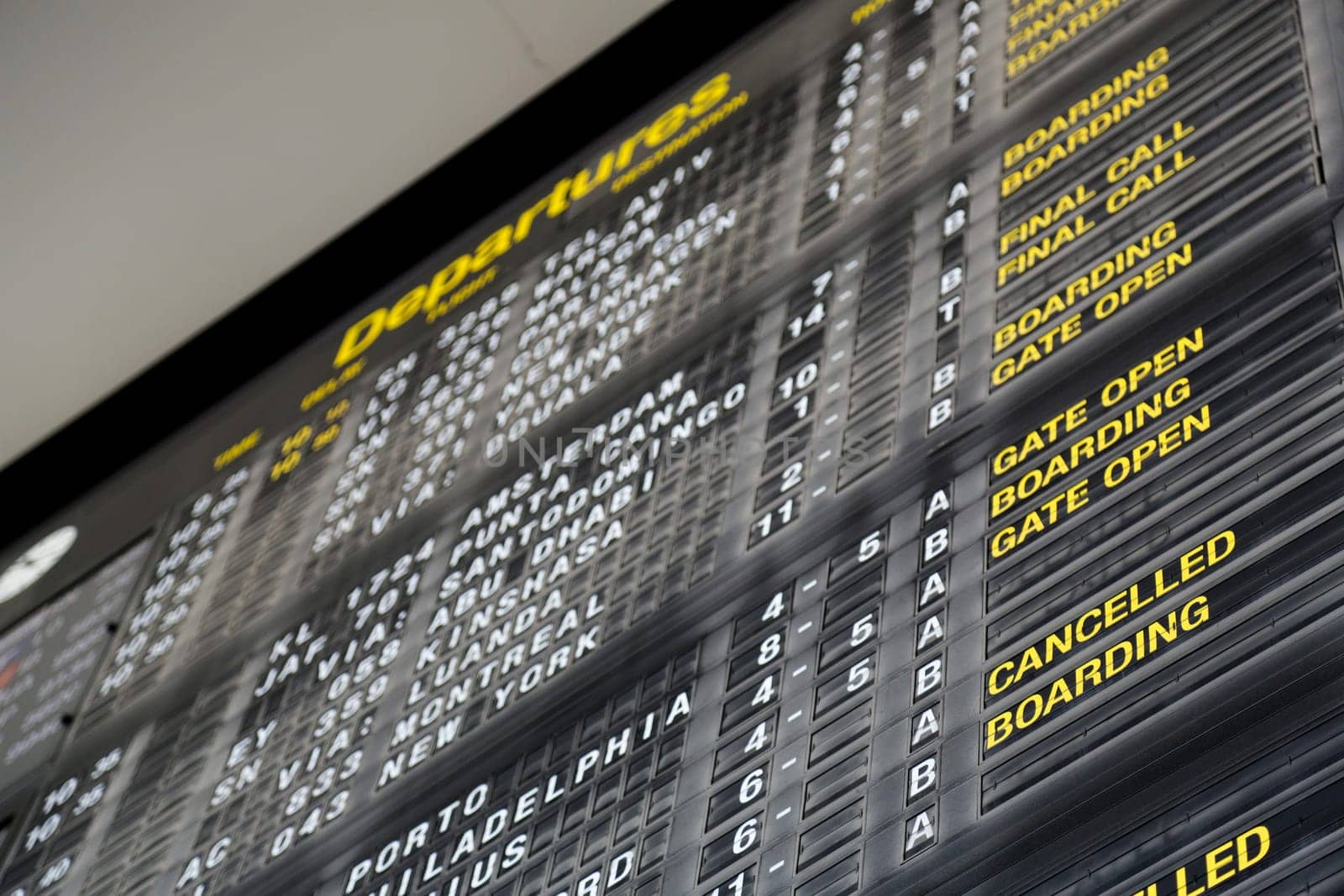 Airport departure board in terminal with flight information