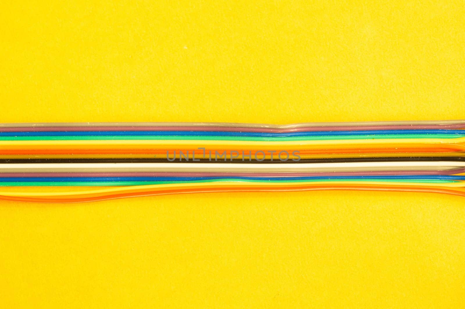 Colorful wires isolated on yellow background. connection wire for electrical schemes and devices. copy space