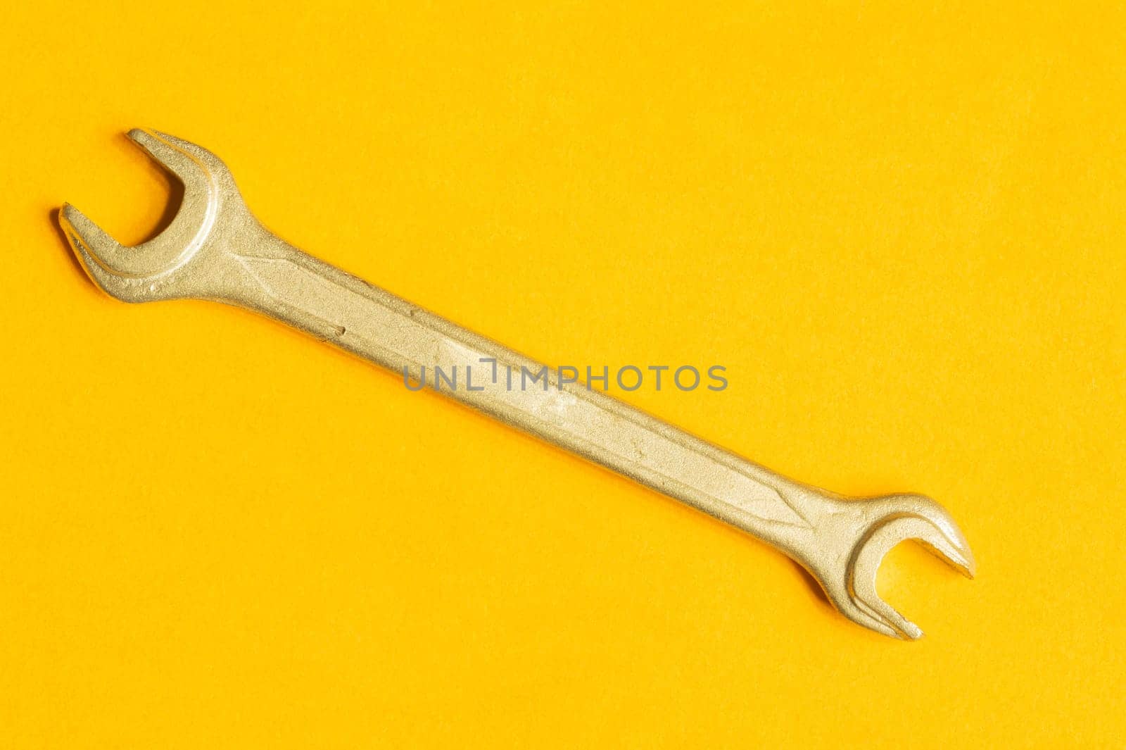 Wrench isolated on yellow background with copy space. working tool