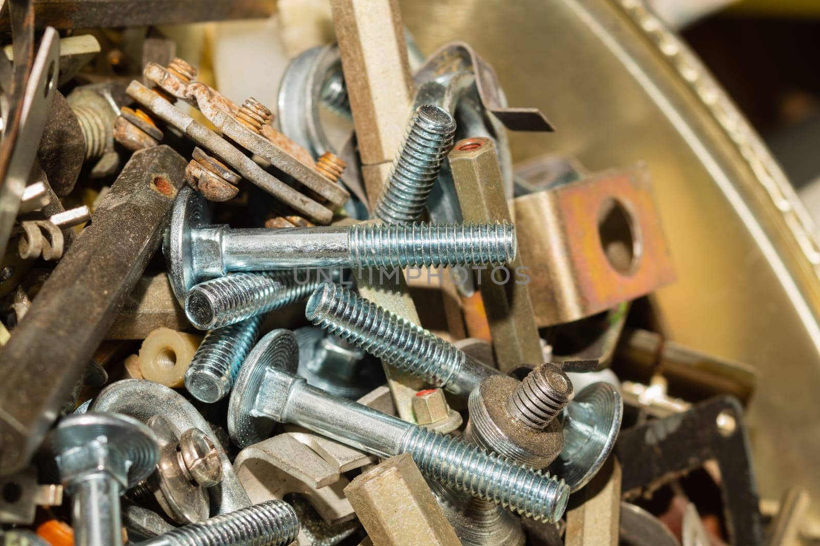 Old screws in a box. a lot of various screws. pile of fasteners in the box close up. carpentry workshop. work tool