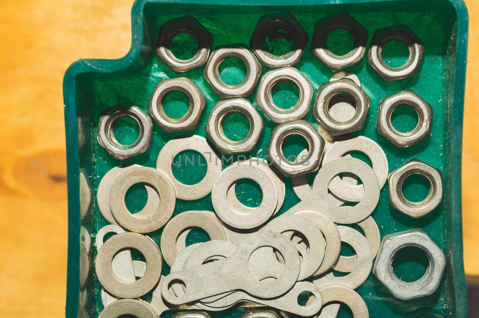 Old screws in a box. a lot of various screws. pile of fasteners in the box close up. carpentry workshop. work tool