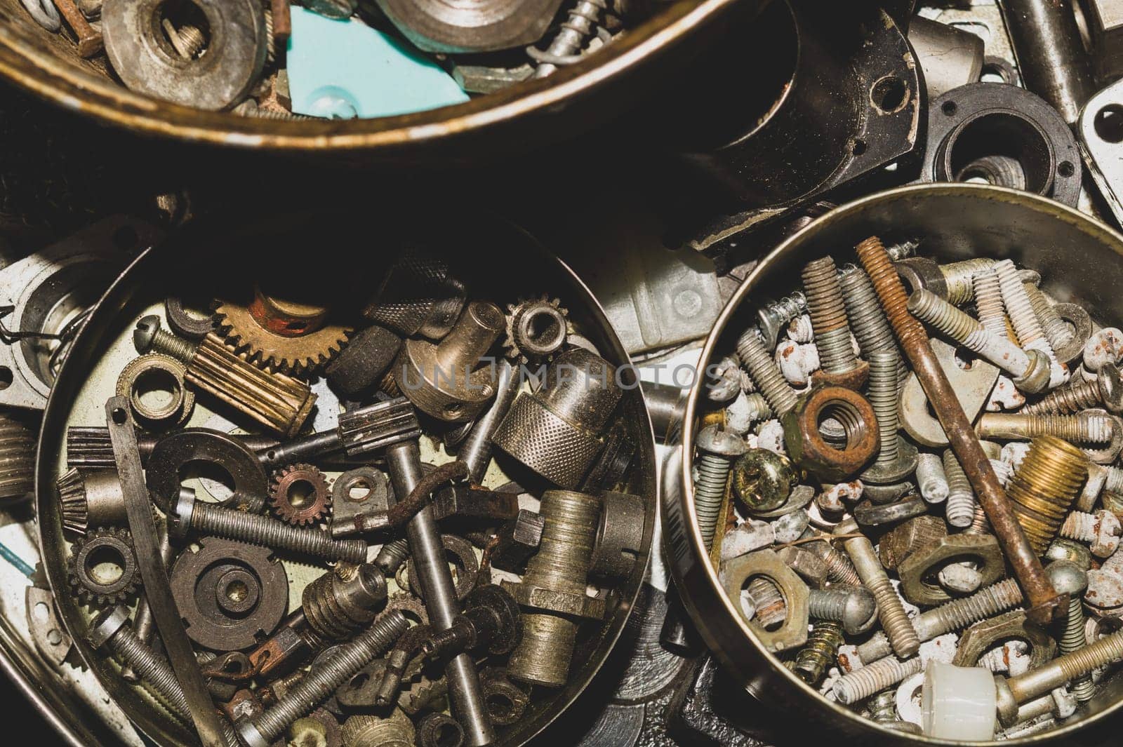 Old screws in a box. a lot of various screws. pile of fasteners in the box close up. carpentry workshop. work tool