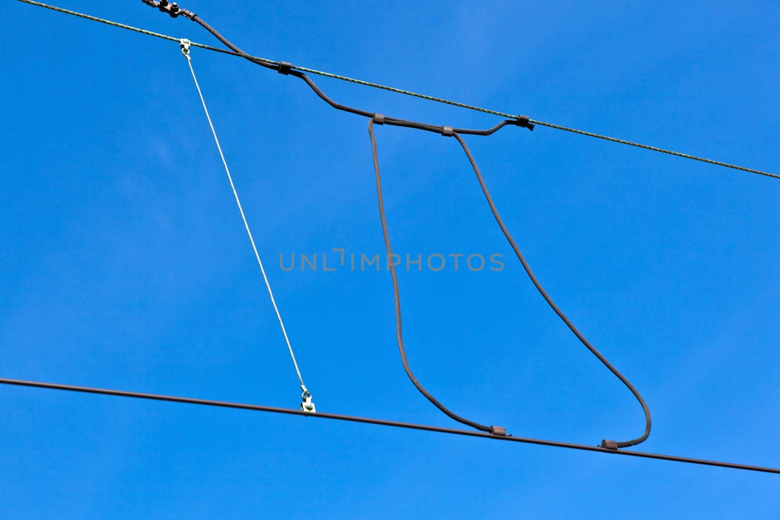 catenary of train under clear blue sky