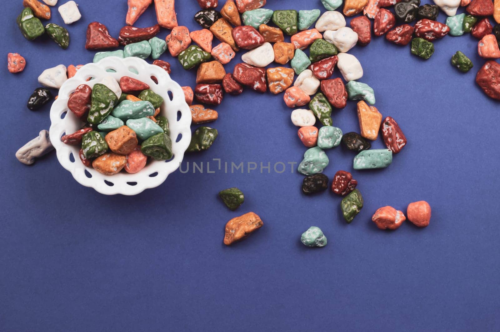 Candy bowl with sweets in the form of colored stones. colorful candies