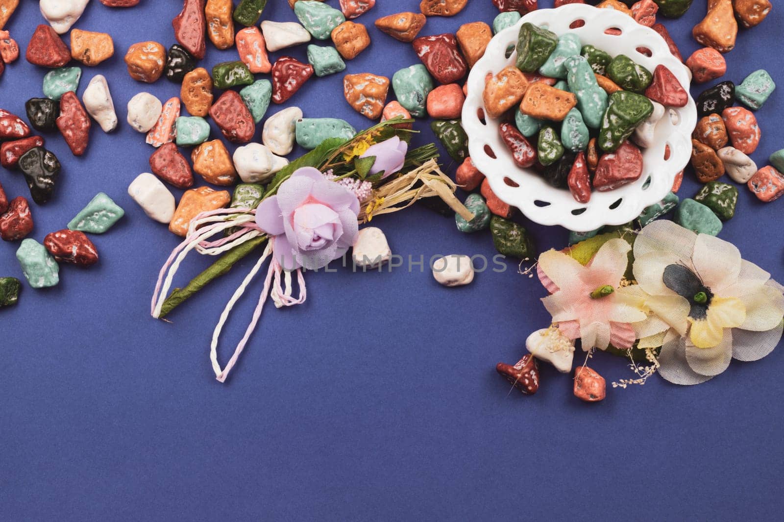 Festive decoration. lollipops and candy pebbles. sweets in the form of colored stones. colored background with colorful candies. copy space