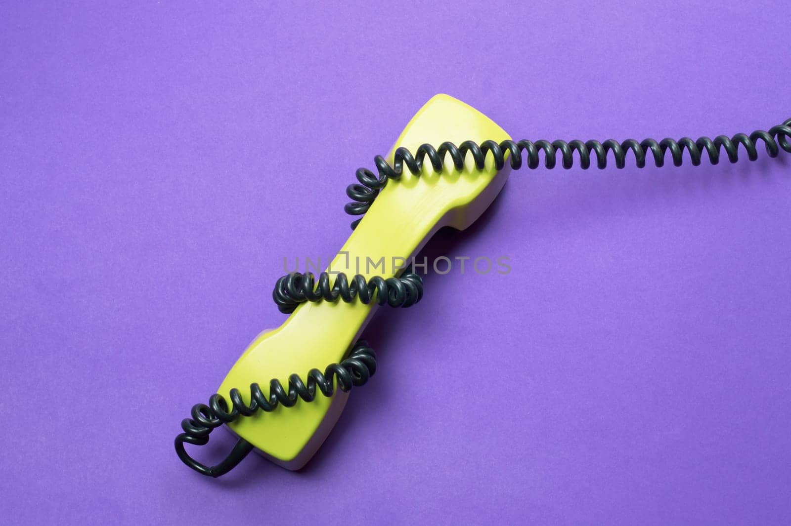 Vintage telephone handset. phone receiver isolated on purple background. old communication technology. copy space