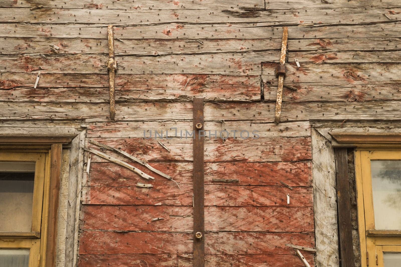 Windows of the old wooden house. wooden plank wall with windows background