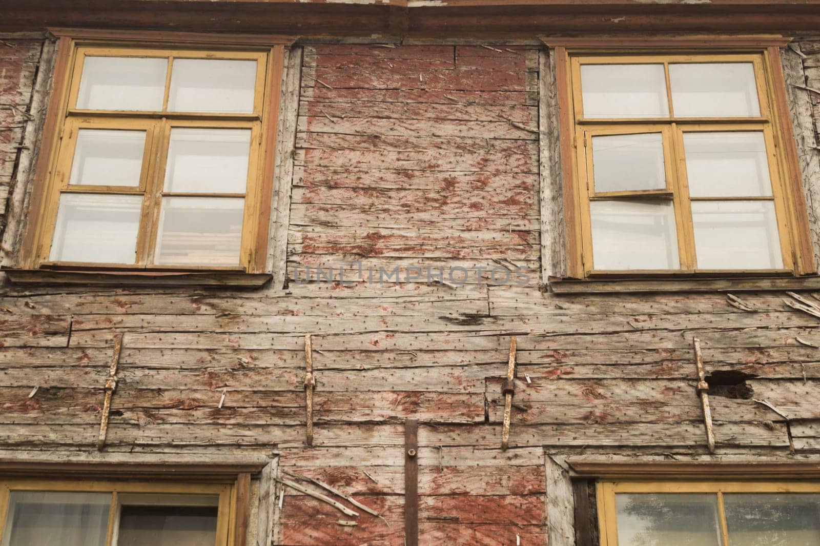 Windows of the old wooden house. wooden plank wall with windows background