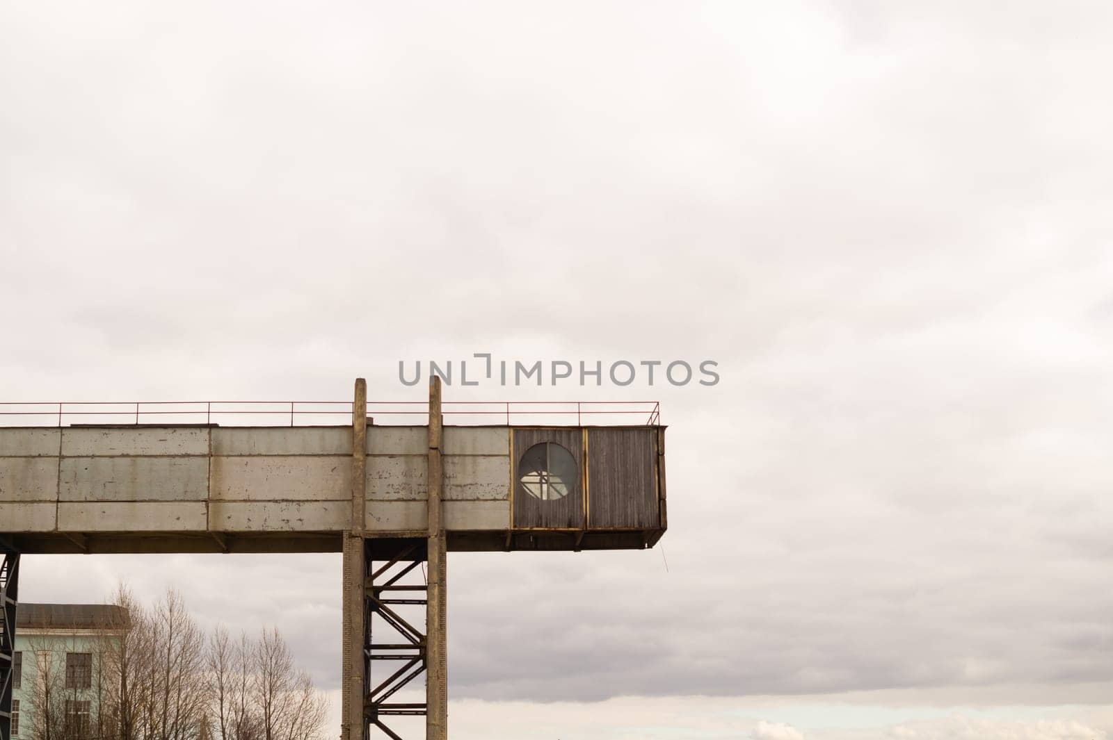 Part of a factory with round window on the sky background. industrial backdrop