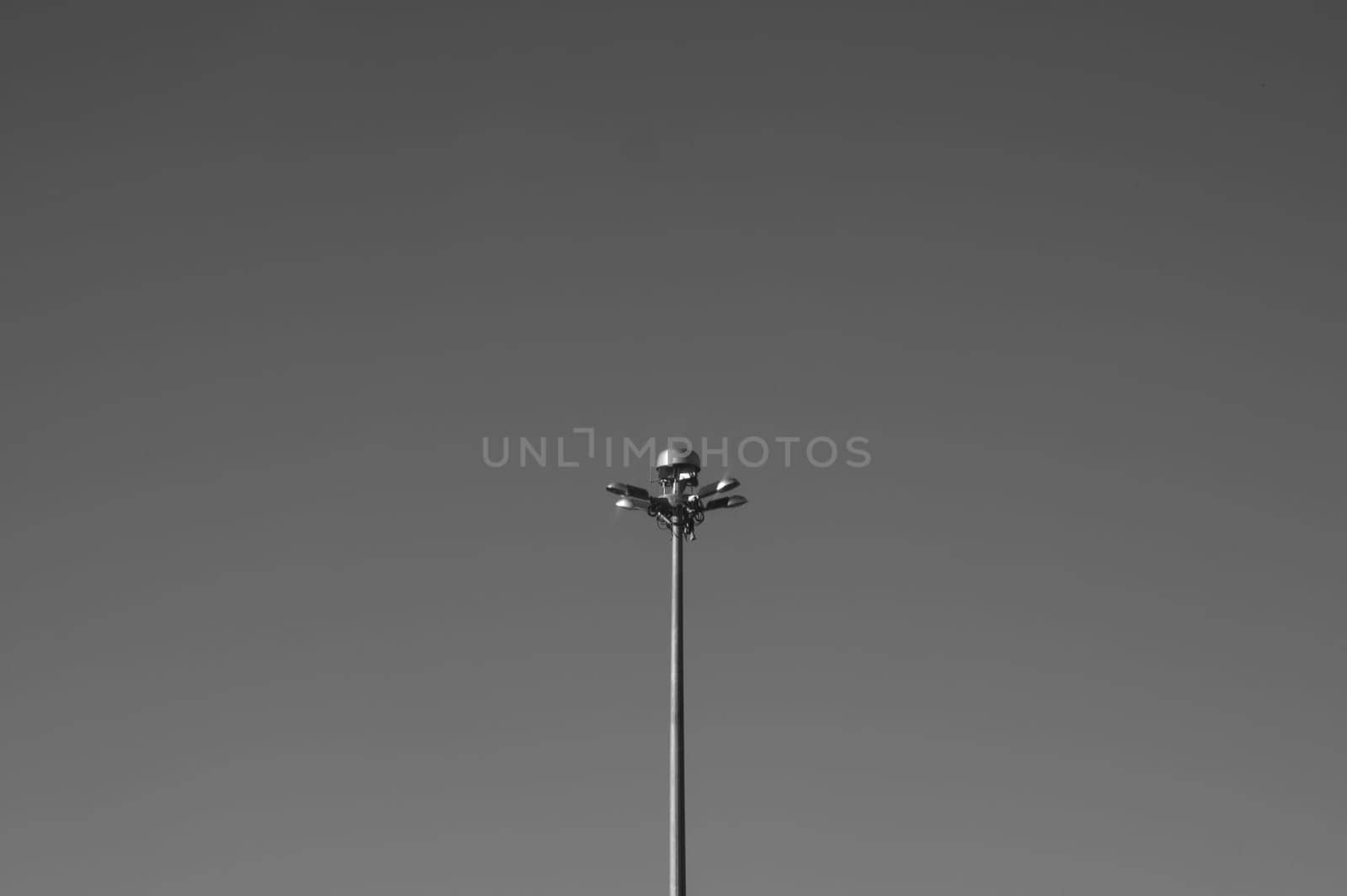Street lamp post standing alone on the sky black and white background