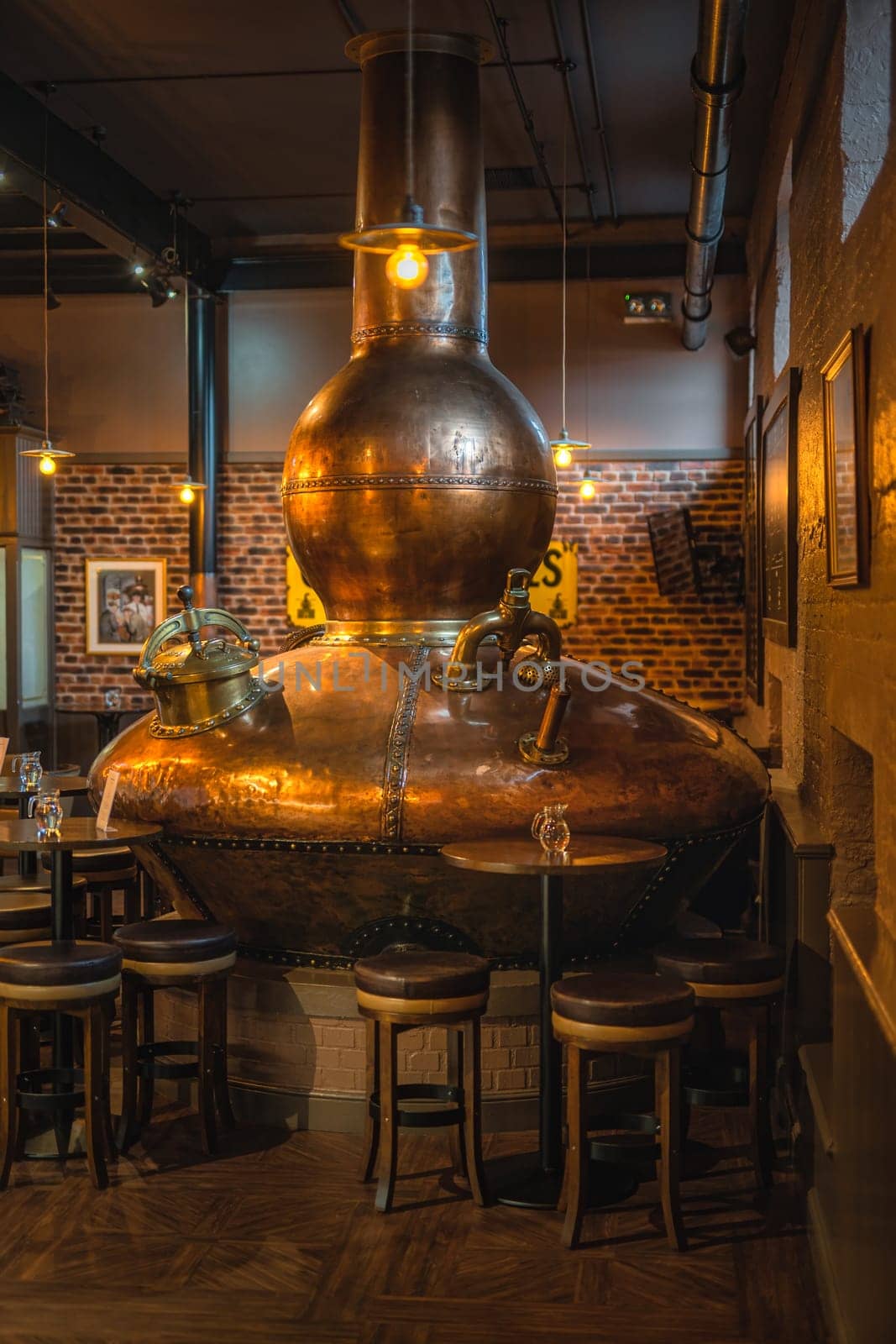 Bushmills, Northern Ireland, Aug 2019 Large, copper fermentation vat in Bushmills whiskey bar as decoration, distillery visitor centre and shop