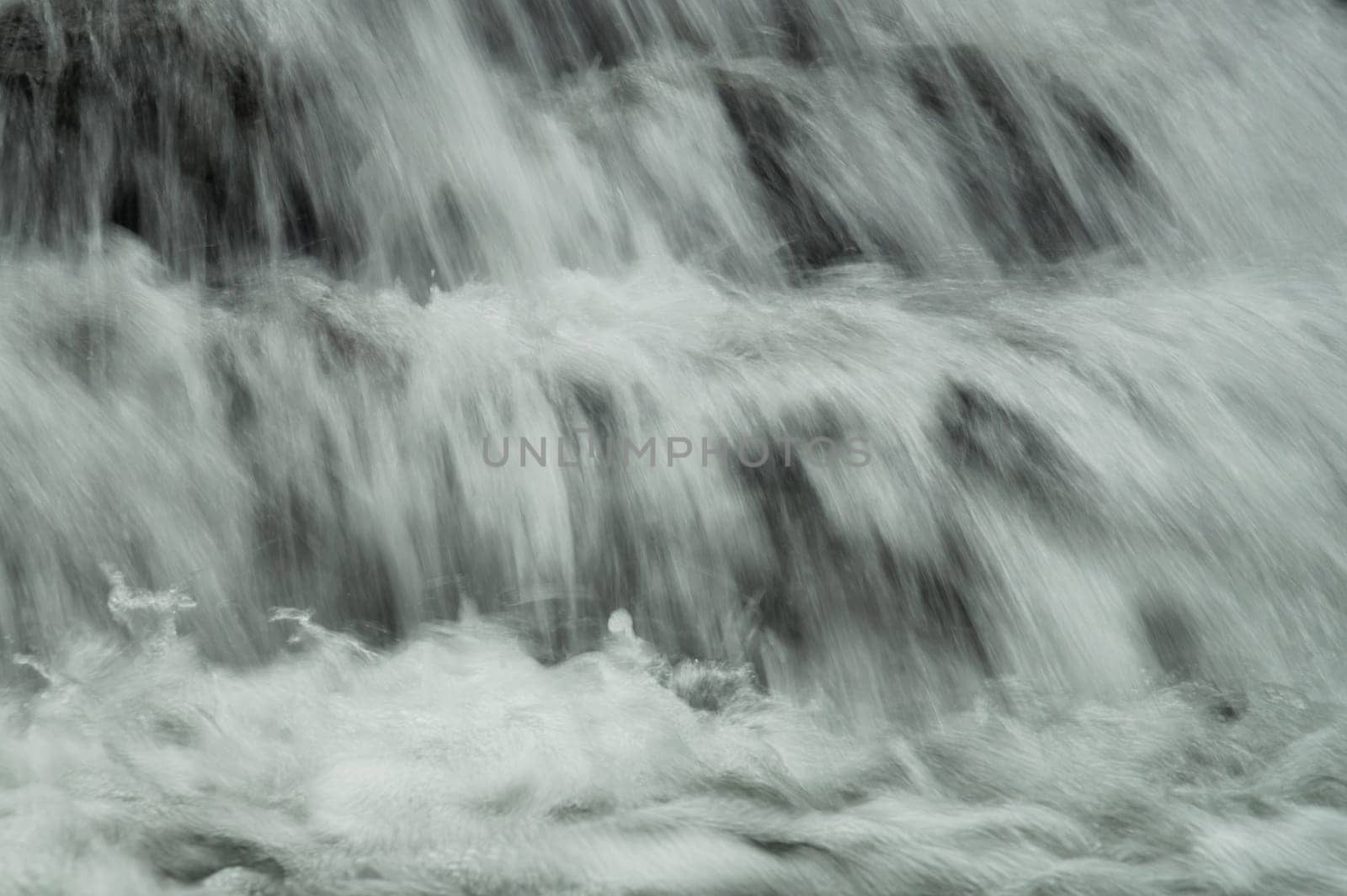 Waterfall background. rushing stream water. abstract backdrop