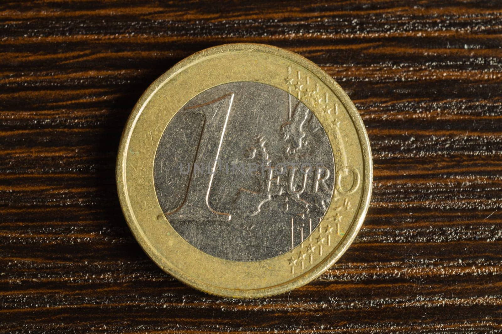 Euro coin on a dark wooden background. european money