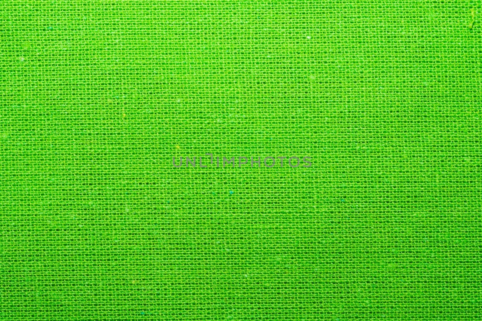Green textile close up. knitted fabric texture. woven material background