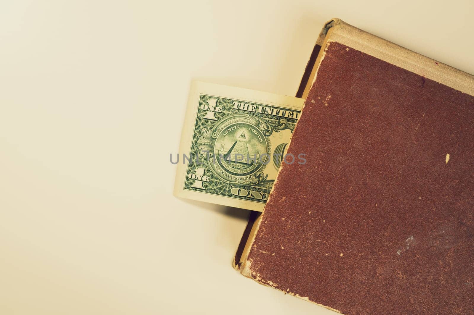 Money in a book. dollar bill used as a bookmark in the book on a white background. copy space