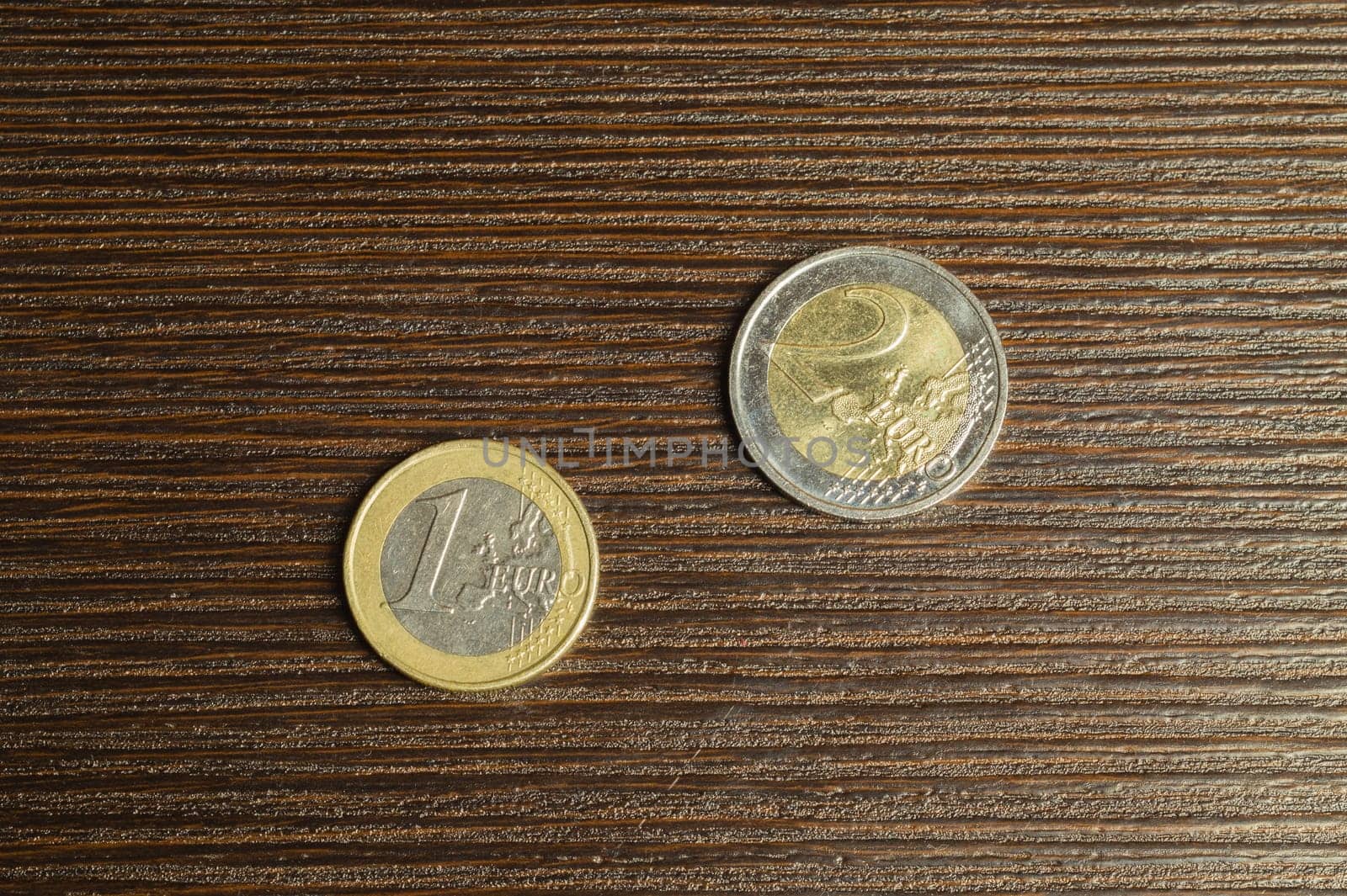 Euro coins on a dark wooden background. european money