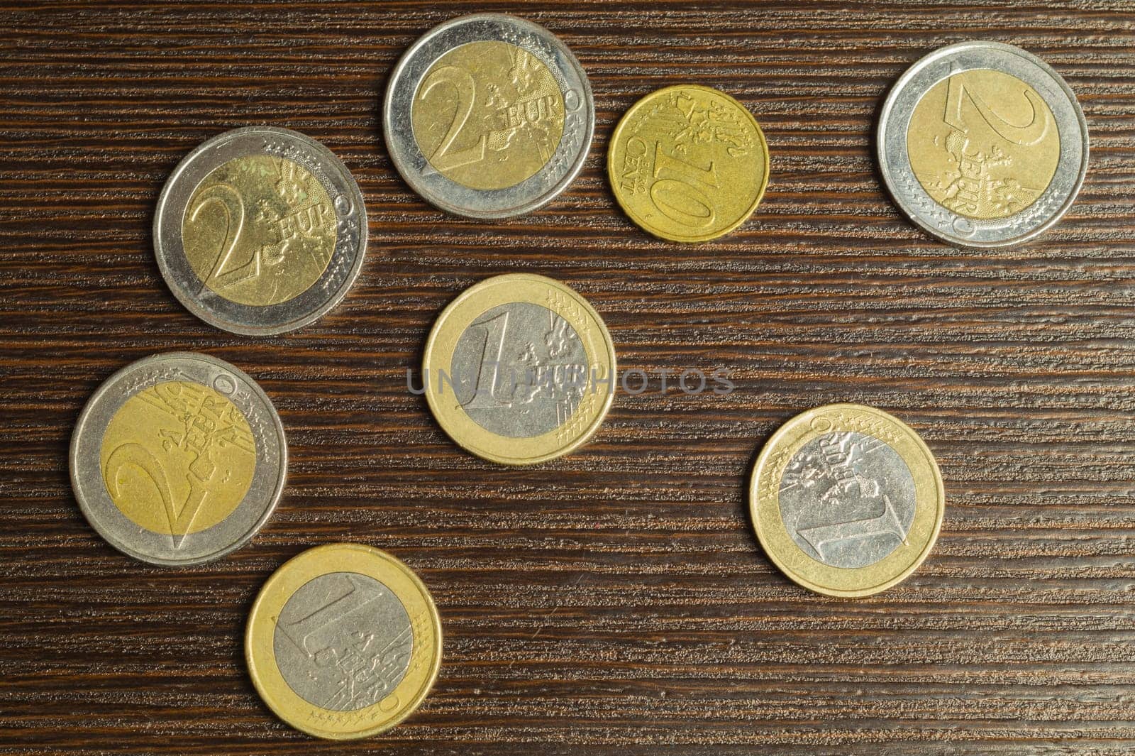 Euro coins on a dark wooden background. european money