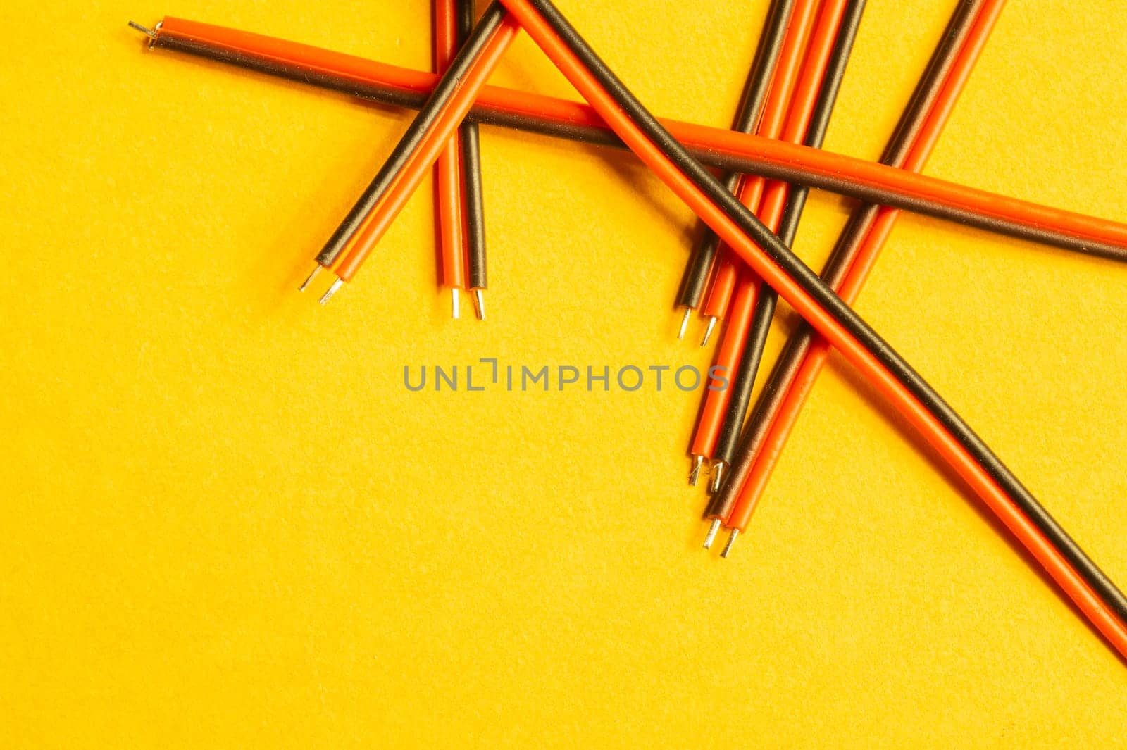 Colorful wires isolated on yellow background. connection wire for electrical schemes and devices. copy space