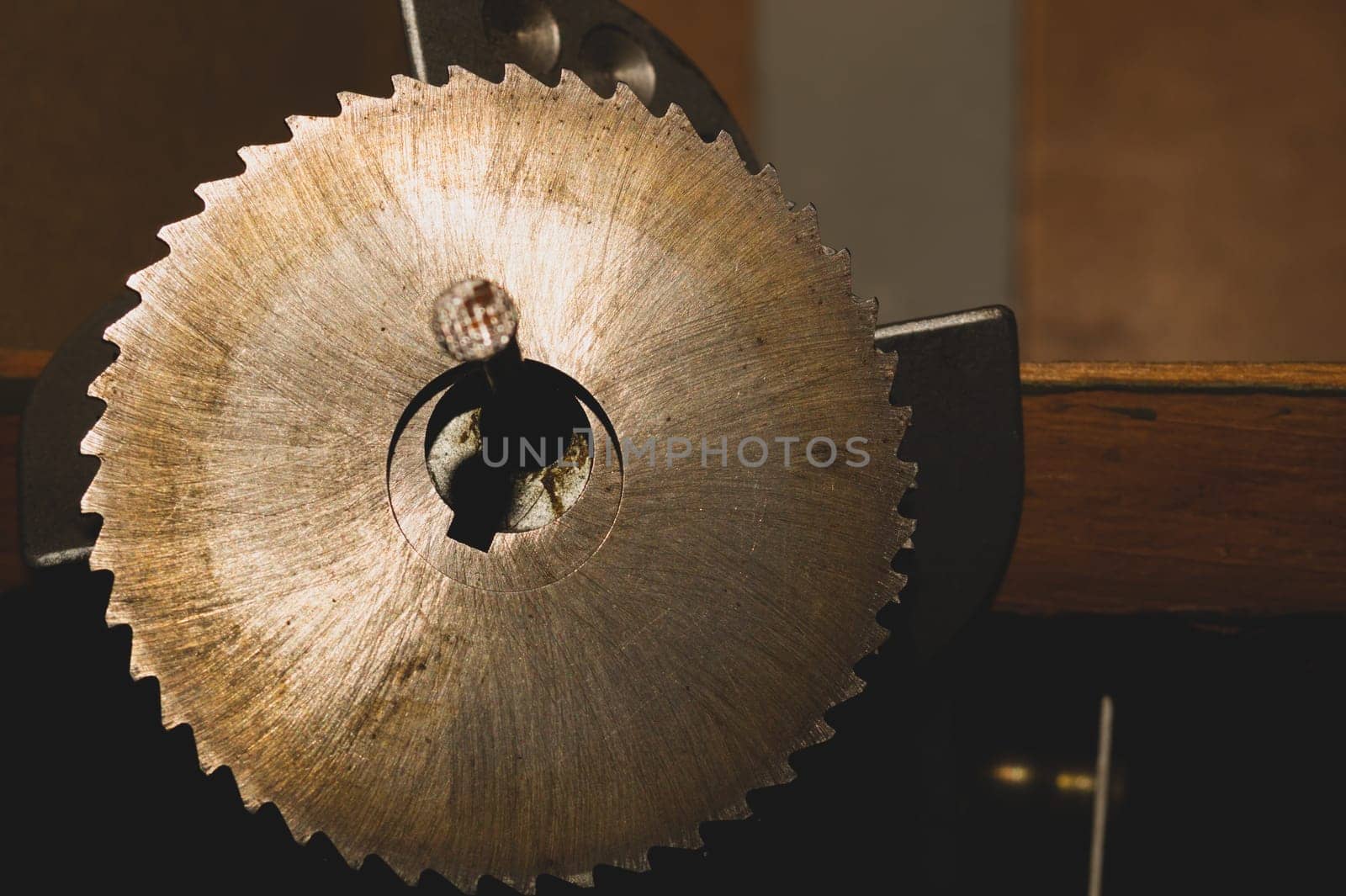 Metal circular saw blade on a wooden background. top view. work tool. carpentry instrument