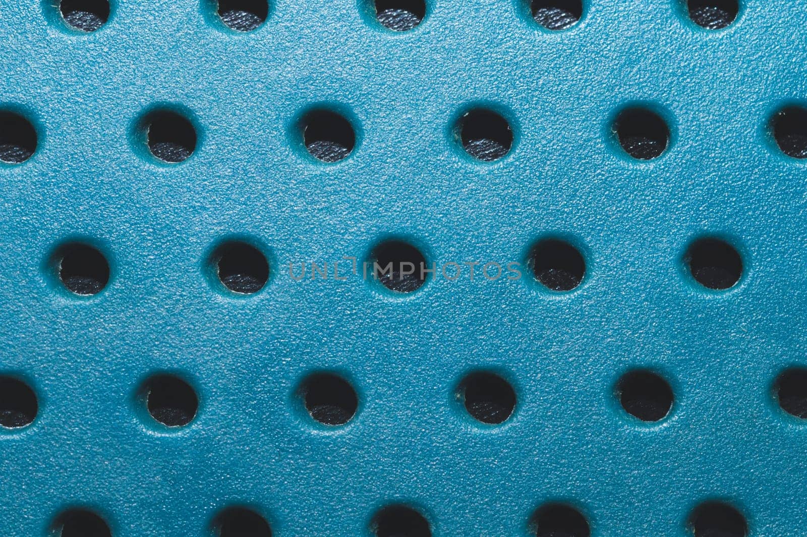 Holes in plastic surface. abstract pattern background