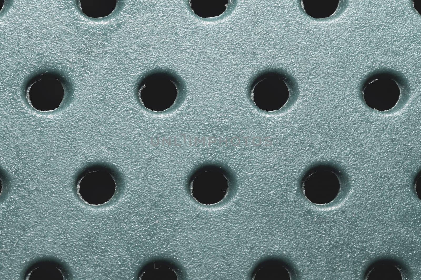 Holes in plastic surface. abstract pattern background