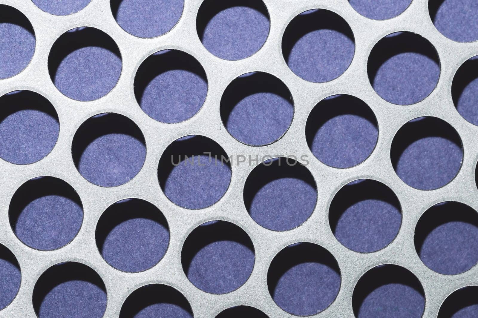 Steel plate with holes. metal grid with round cells. modern background. iron mesh