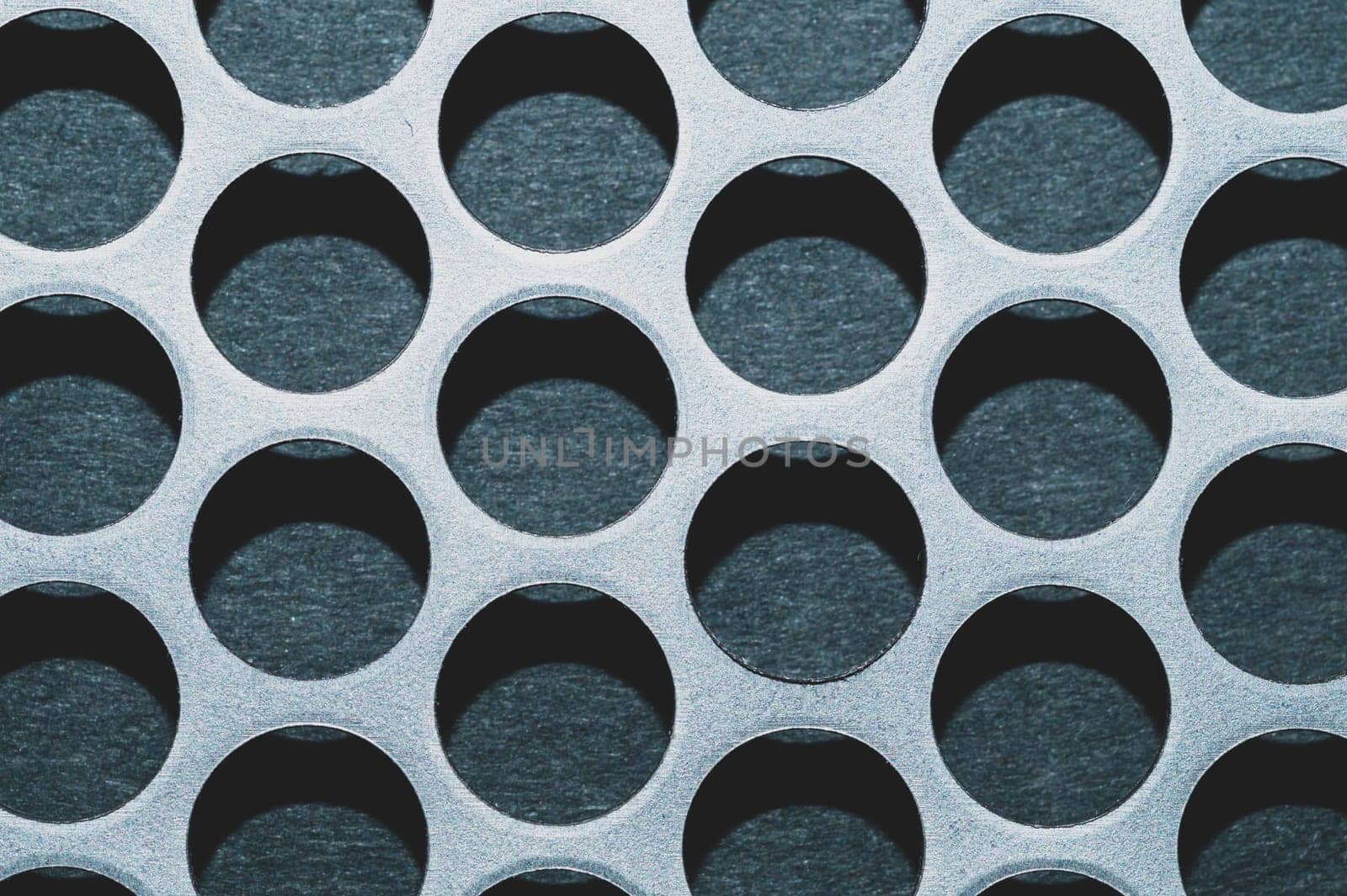 Steel plate with holes. metal grid with round cells. modern background. iron mesh
