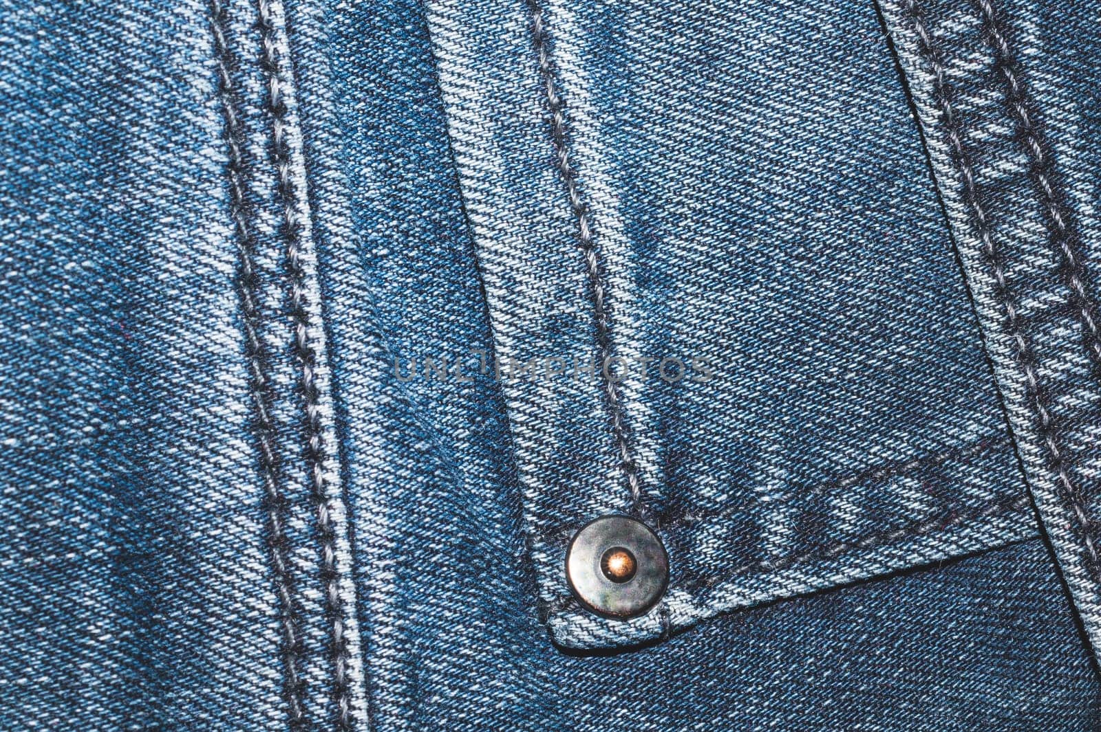 Jeans background with seams. denim texture close up. fabric backdrop with stitches