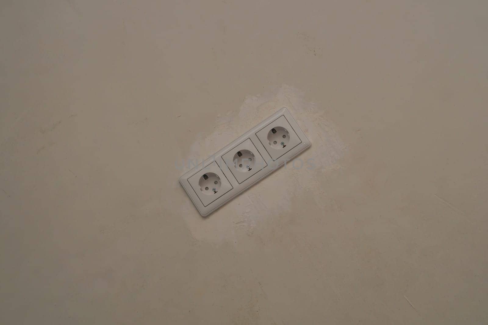 Power socket in the wall. electrical outlet close up. process of renovation