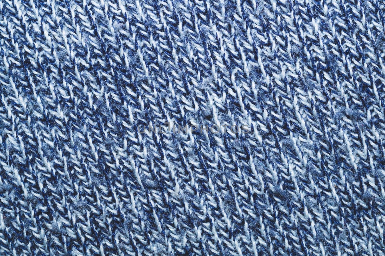 Blue knitted background. woolen texture. fibers pattern close up