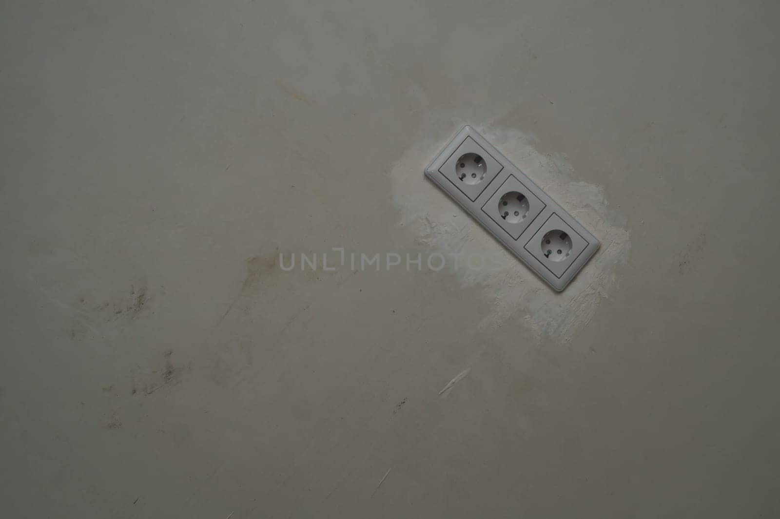 Power socket in the wall. electrical outlet close up. process of renovation