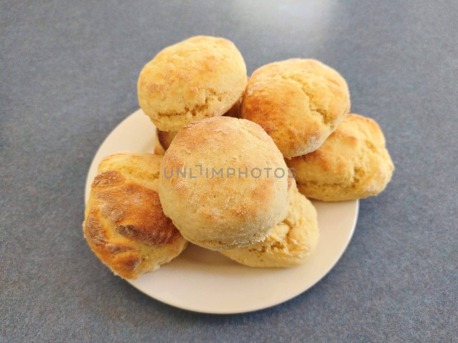 Home cooked scones on a white plate