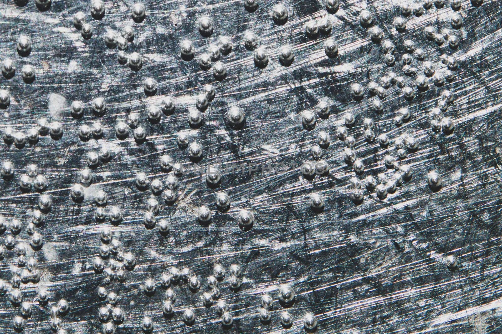 Boiling water bubbles close up. abstract texture with water drops on steel plate. gray rough background