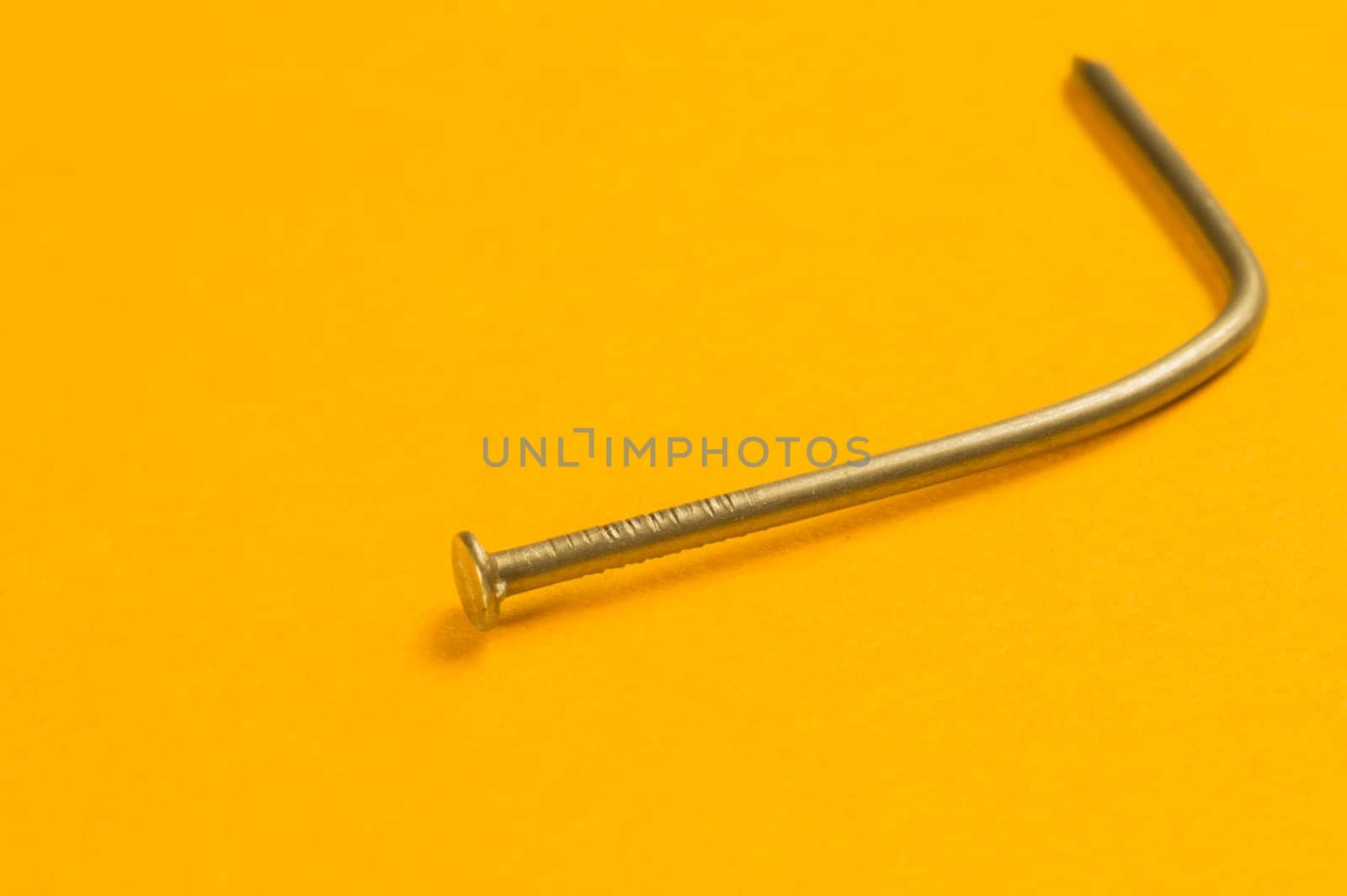 Steel screw on a yellow background. working tools
