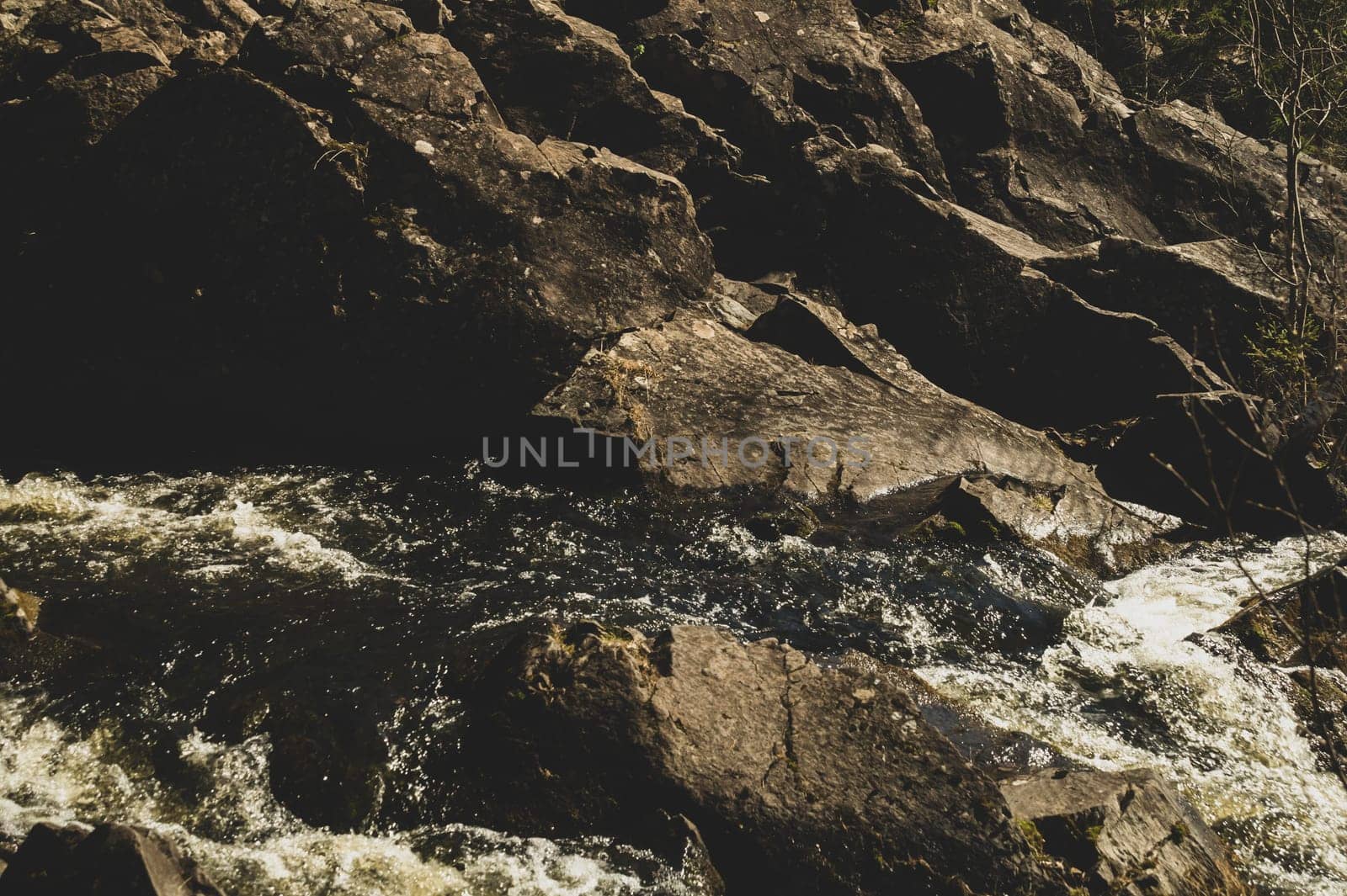 Waterfall nature background. rushing stream water. rocky flowing river
