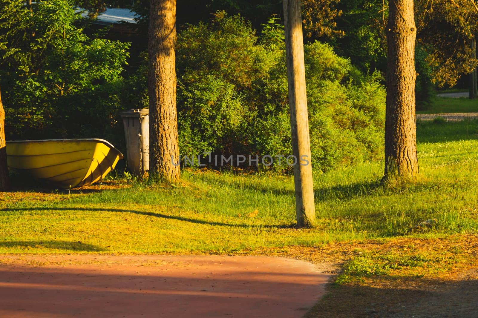 Yellow boat on the courtyard under the morning sunlight. fishing equipment