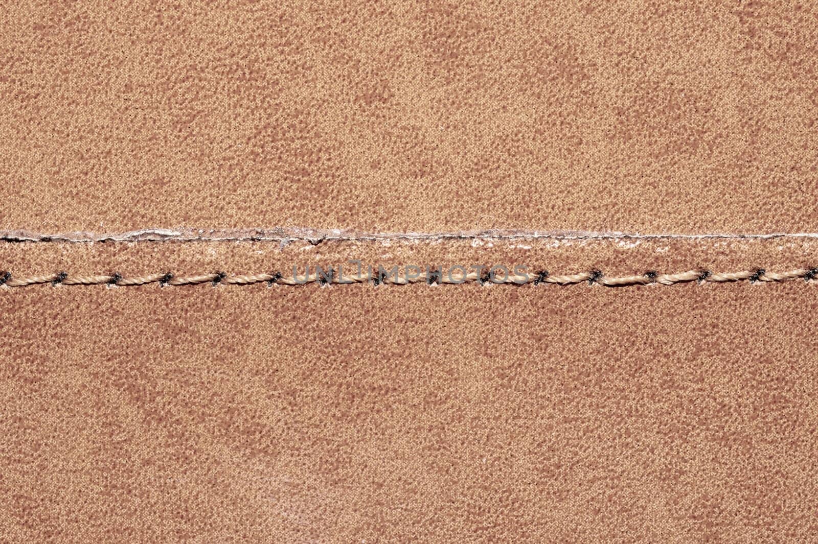 Brown leather texture with a linear stitch. material with seam