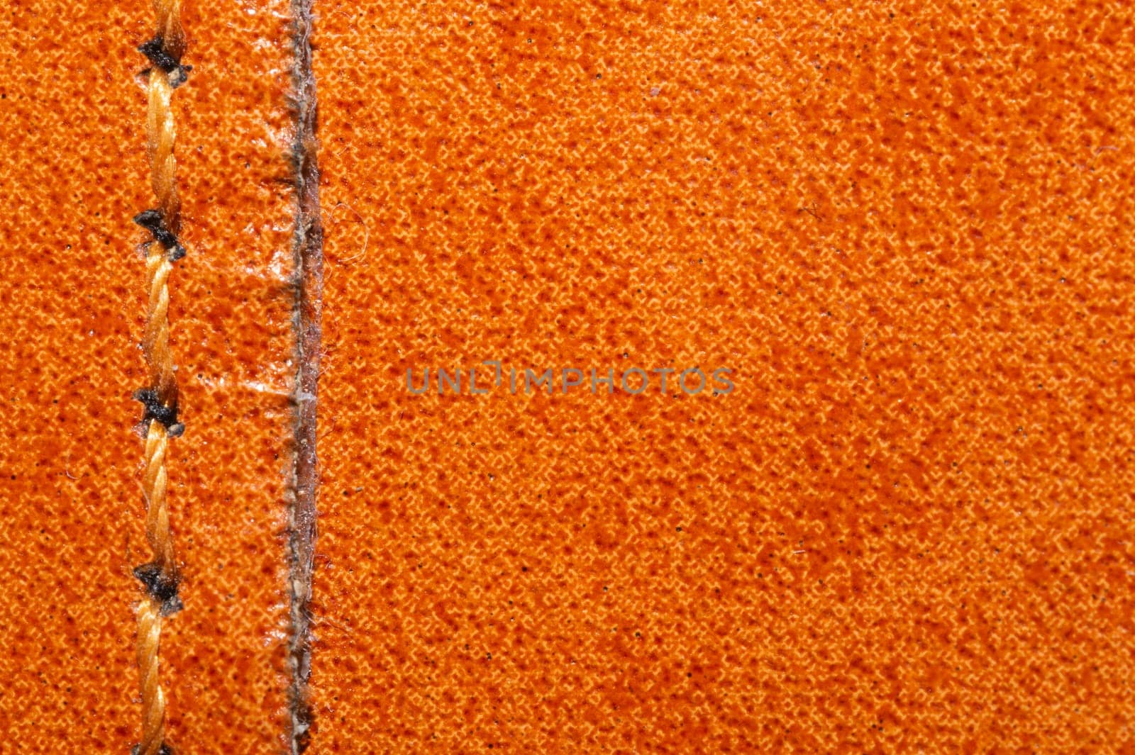 Brown leather texture with a linear stitch. material with seam